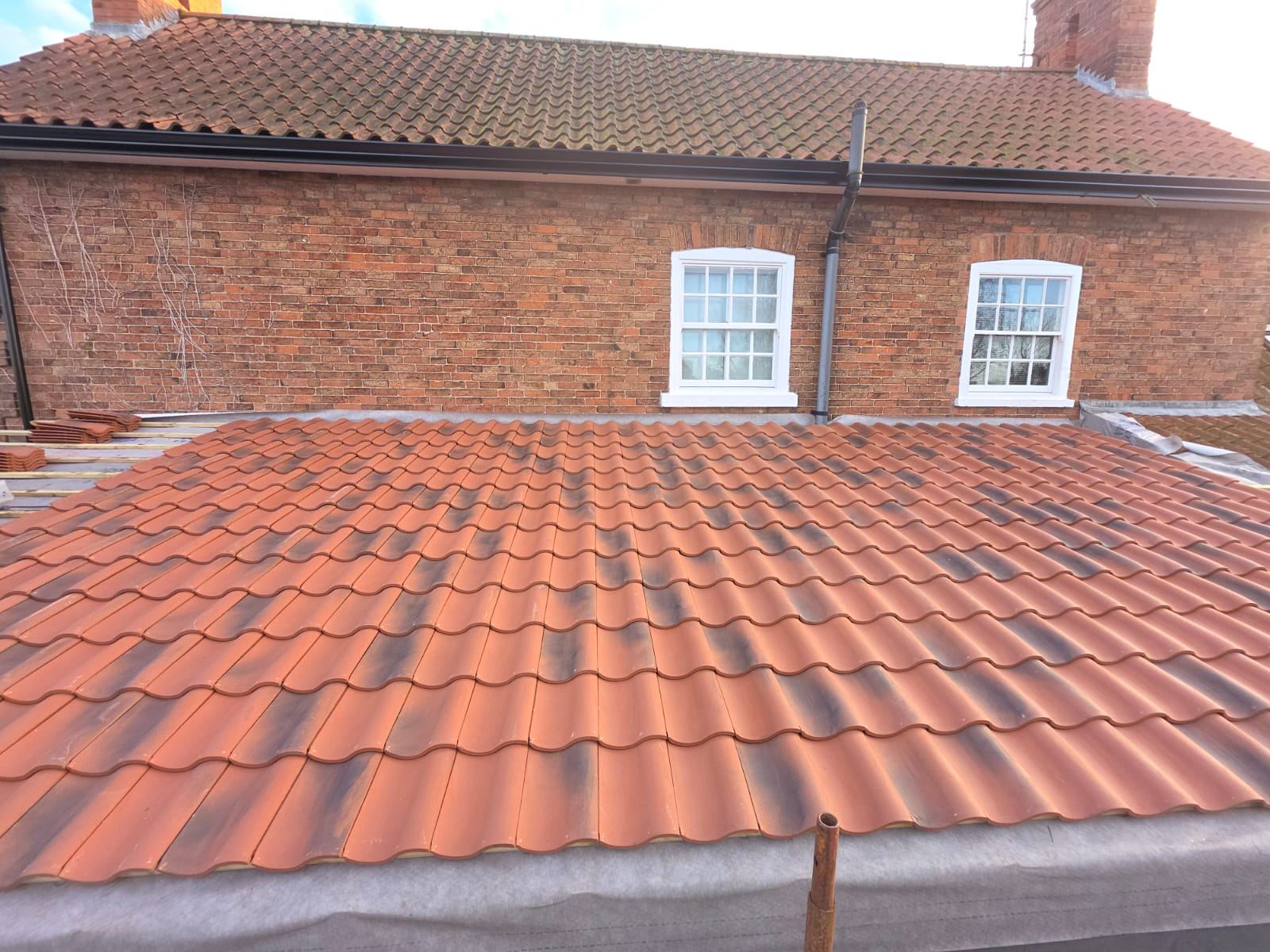 Re-roofed range below the farmhouse